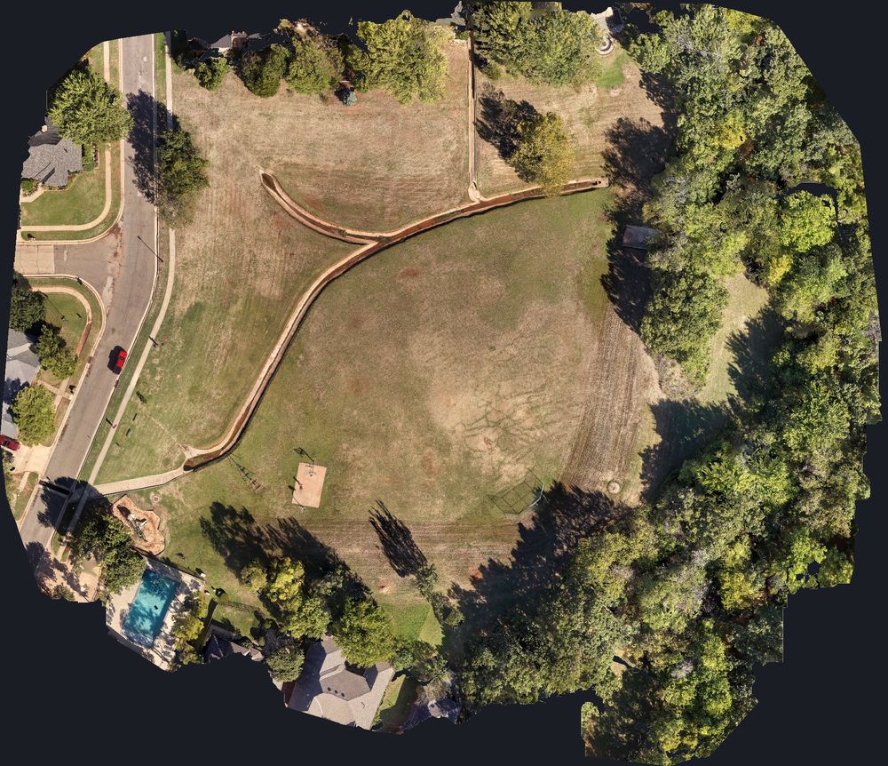 Top-down orthophoto of a stormwater detention basin stitched from drone photos